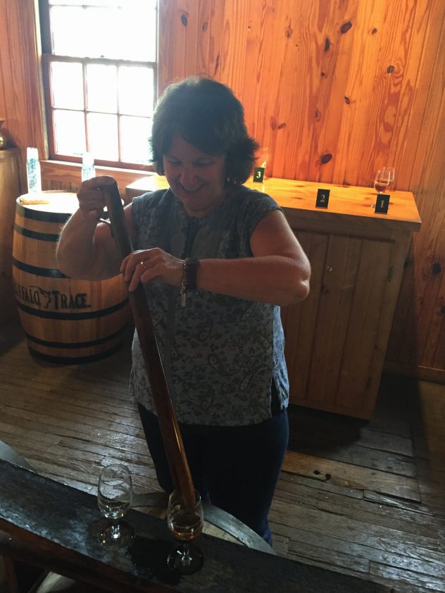 Bev Taylor of Cork & Barrel drawing a bourbon sample